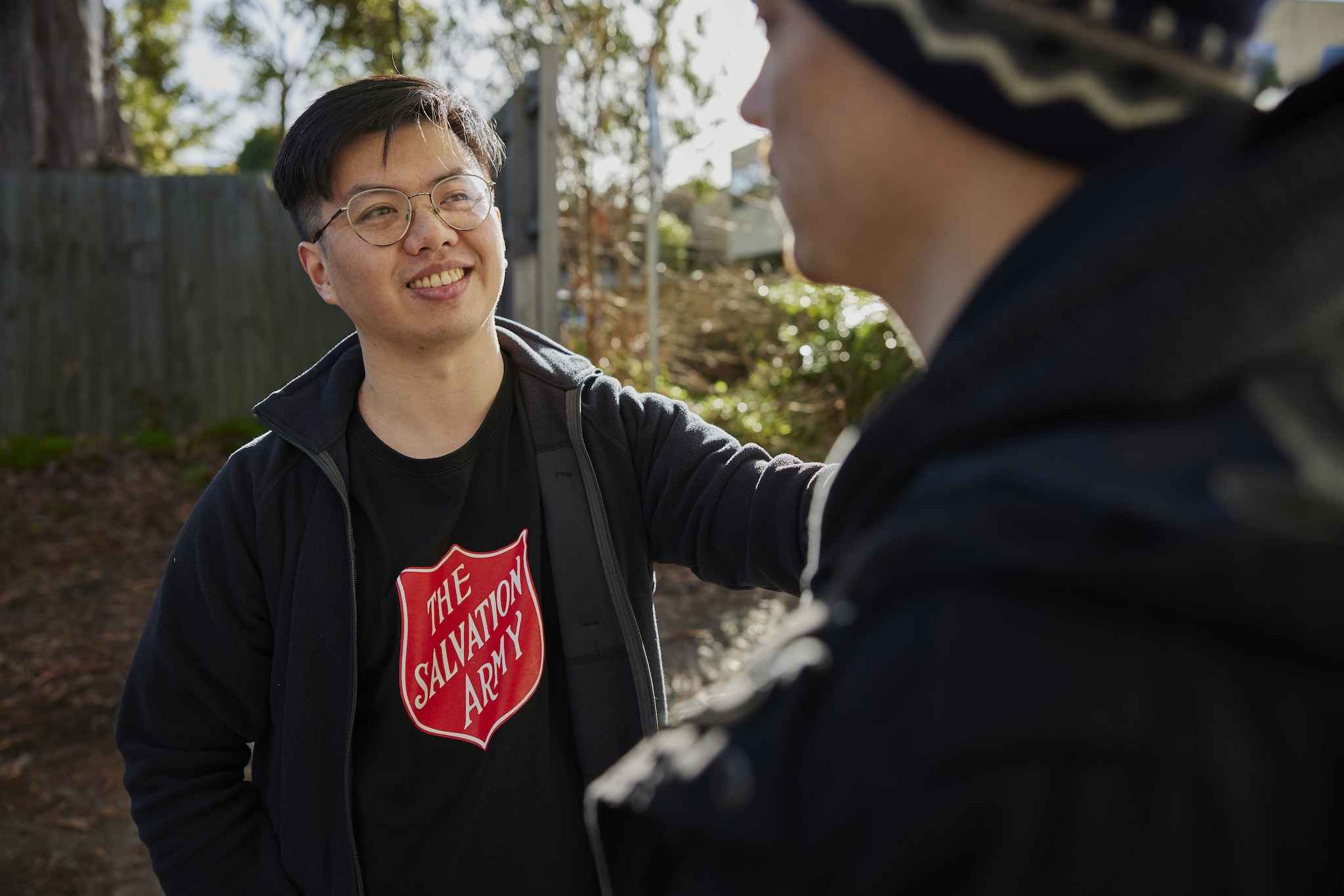A Salvos worker comforts a young homeless man sheltering in a local laneway.