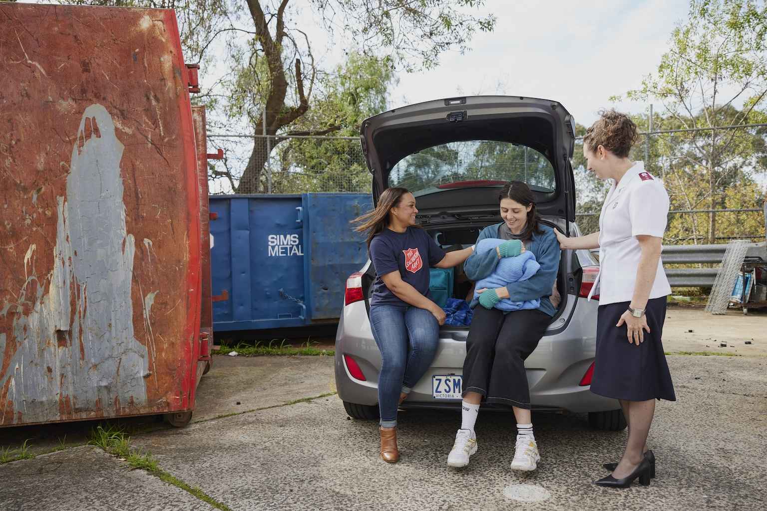 A Salvos Volunteer and Officer support a young woman living out of her car.