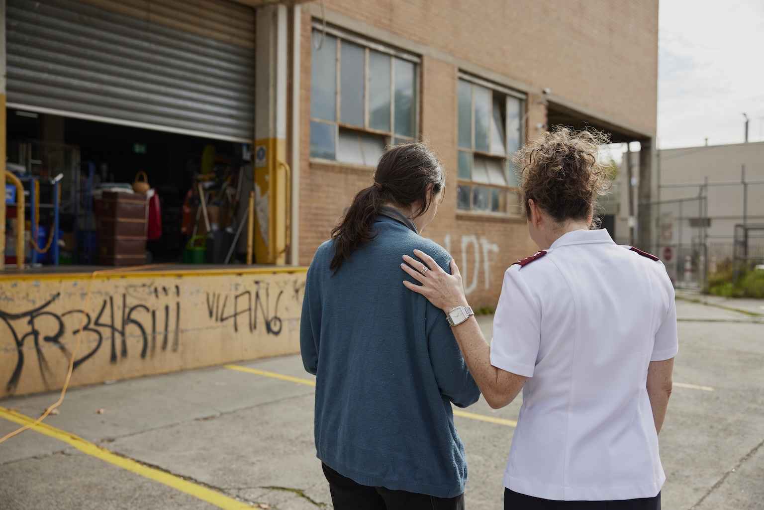 A Salvos Officer comforts a young woman who has been sleeping rough.